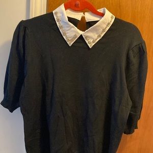 Black puffed sleeve sweater with white jeweled collar.  Size medium.